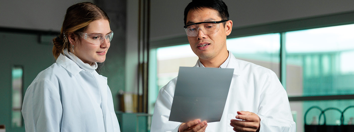 professor and student interact in laboratory