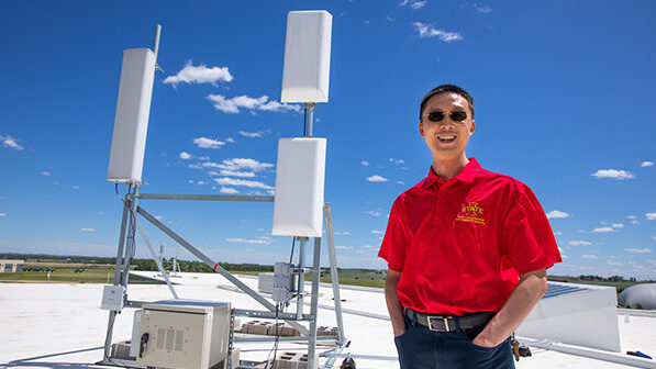 Hongwei Zhang on rooftop with wireless transmission equipment