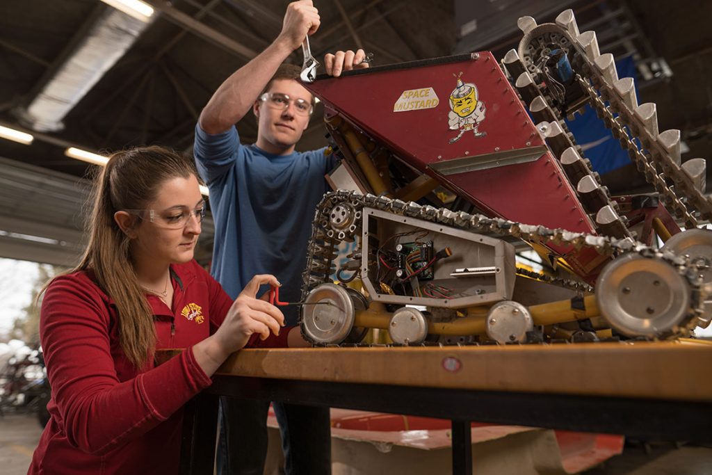 students in lab working on space mining robot