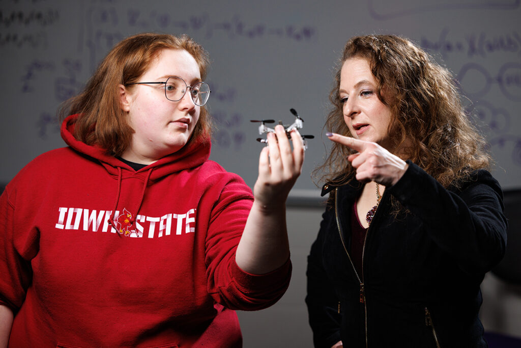 professor and student examine a small drone