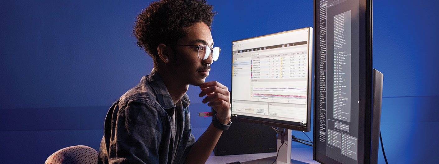 student sitting at desktop computer