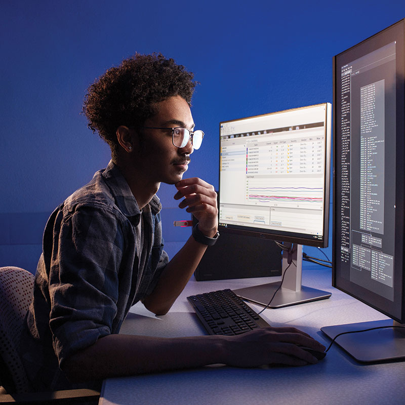 student sitting at desktop computer