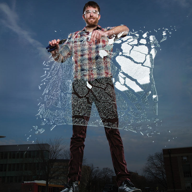 student breaking glass pane