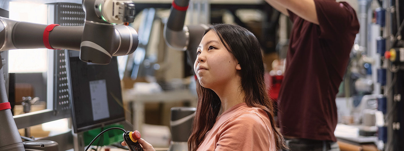 students working with robotic arms