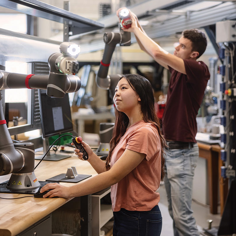 students working with robotic arms