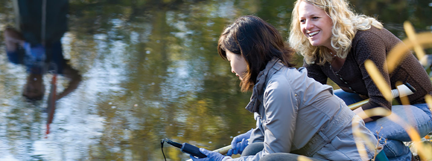 student and professor testing water quality