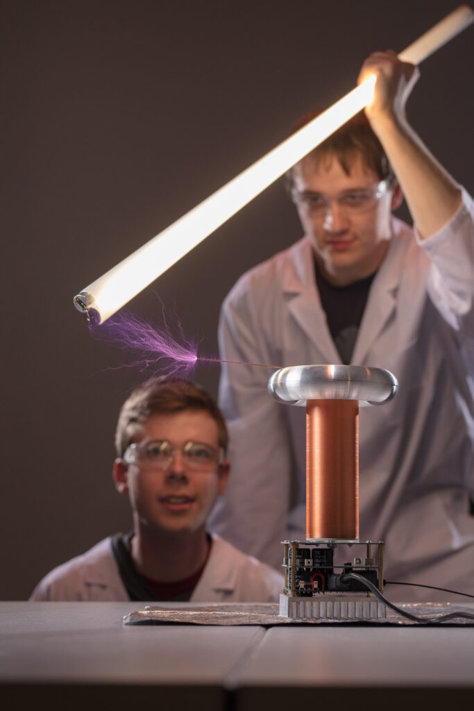 students in laboratory testing tesla coil