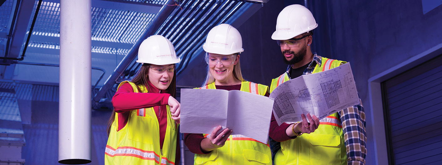 students with faculty member on construction site