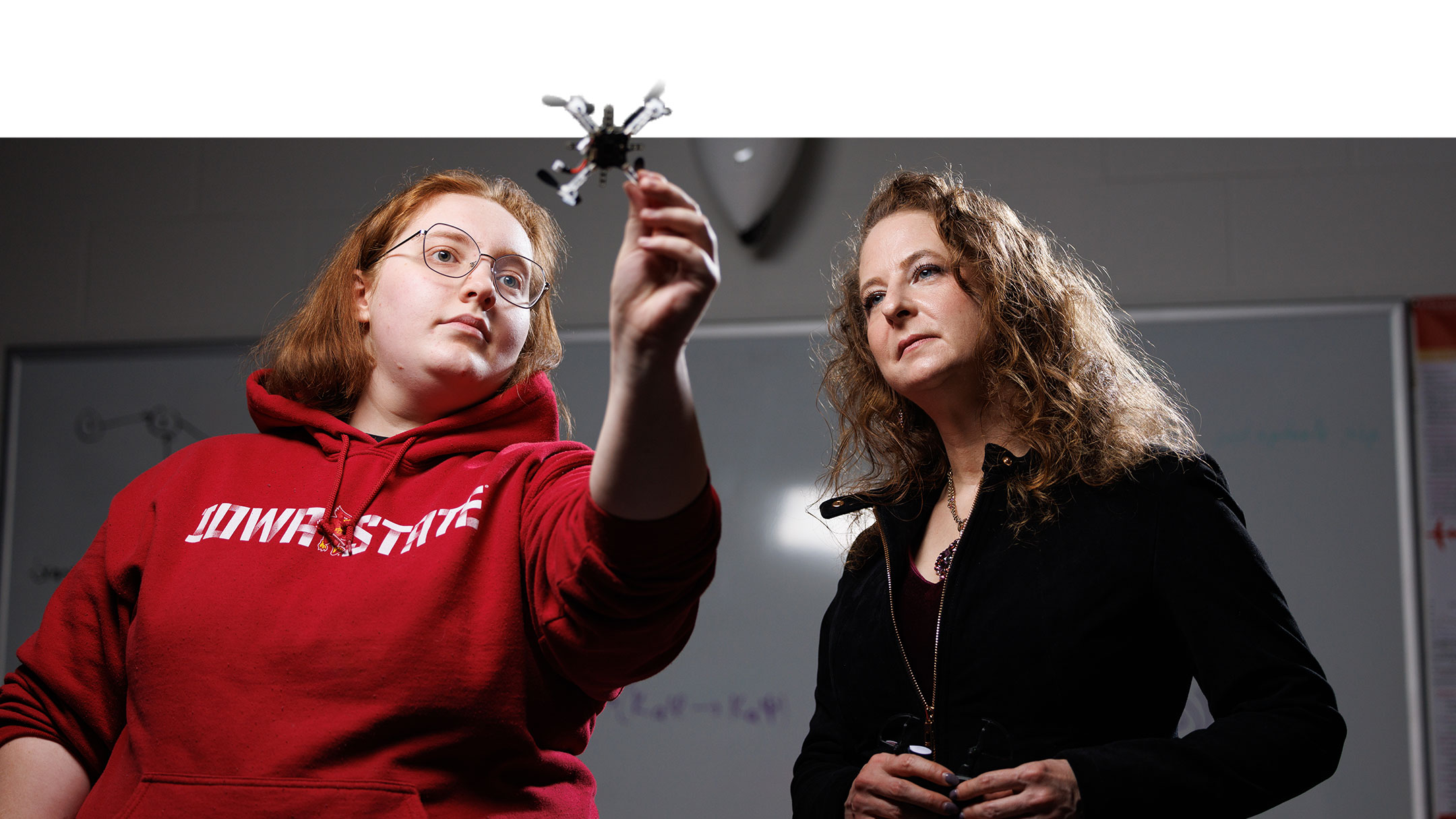 professor and student examine hand-held drone