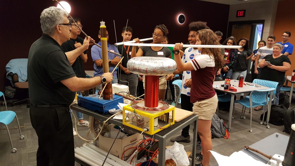 instructor and students interacting with tesla coil experiment
