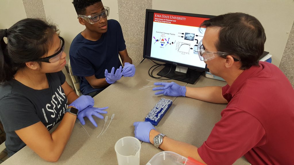 instructor and students interact in lab setting