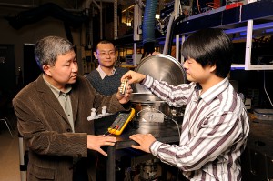 Xinwei Wang, Guoqing Liu and Xiaopeng Huang, left to right, show the instruments they used to study the thermal conductivity of spider silk