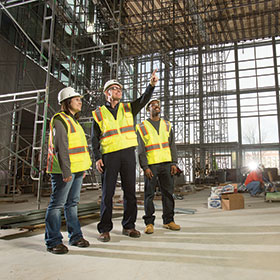 researchers examine building interior during construction