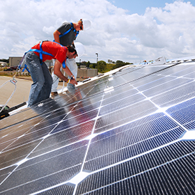 students working on solar array