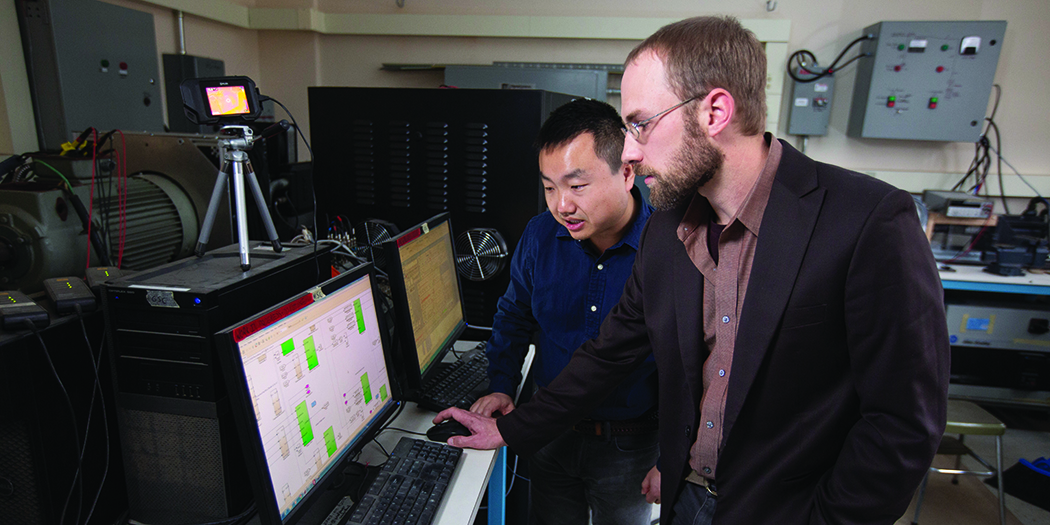 (Zhaoyu Wang, assistant professor of electrical and computer engineering, and Nick David, graduate student in electrical and computer engineering)